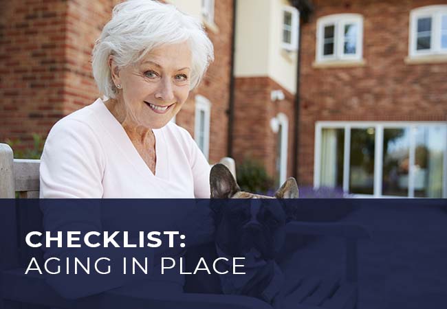 An elderly woman holding a dog