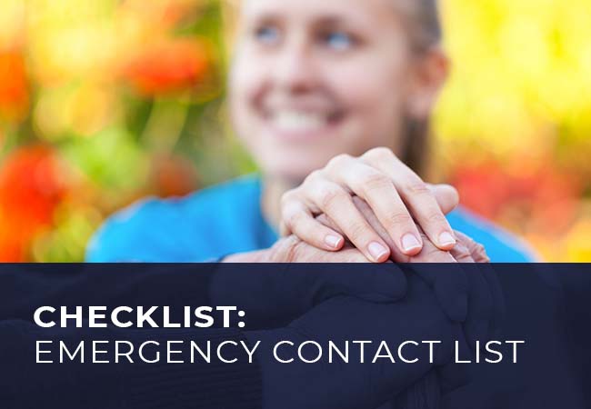 A kind woman holding the hand of an elderly person
